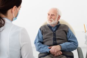 older man having a dental consultation and discussion with his dentist